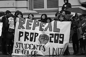 protestors holding a banner to repeal Prop 209