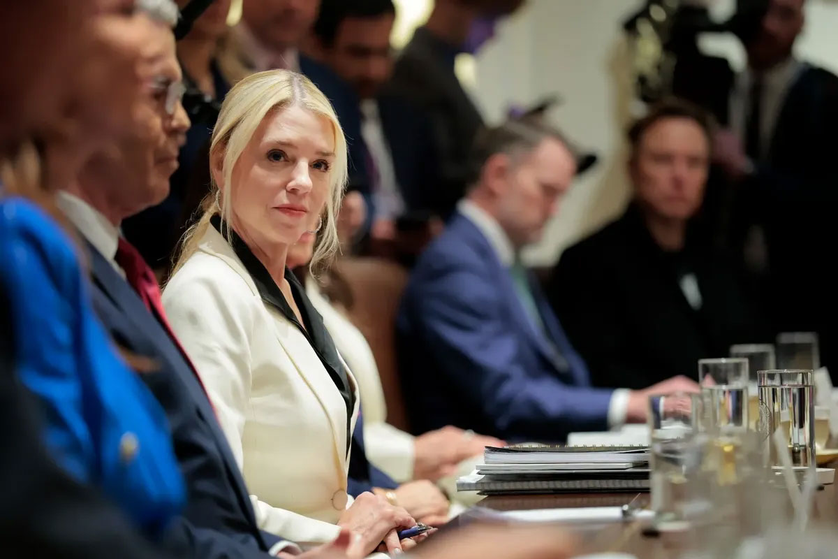 photo of Pam Bondi sitting with other cabinet members at a table